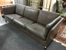 A late 20th century Danish brown leather three seater settee