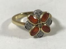 An 18ct gold fire opal and diamond cluster ring, size N.
