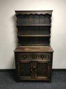 A carved oak kitchen dresser