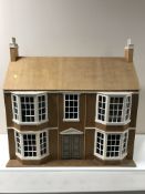 A large unfinished doll's house and a large quantity of furniture and accessories
