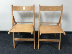 A pair of beech framed folding school chairs (2)