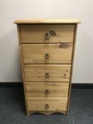 A pine narrow five drawer chest