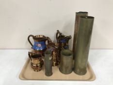 A tray of four brass ammunition shells and four copper lustre jugs