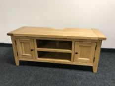 A contemporary TV stand fitted with cupboards