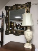 An ornate French style gilt framed mirror and a table lamp