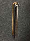Two walking sticks with silver mounts together with a further walking stick and walking cane (4)