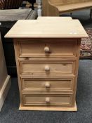 A pine four drawer bedside chest