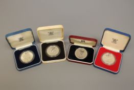 Three silver proof commemorative crowns and an Isle of Man Manx Cat silver crown (4)