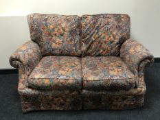 A pair of two seater bed settees in floral fabric