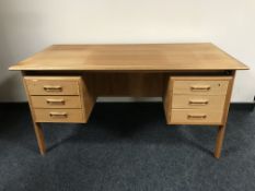 A mid 20th century teak twin pedestal desk