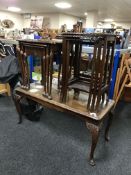 A mahogany coffee table and two nests of three tables