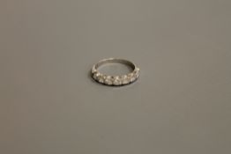 An 18ct white gold seven stone diamond half eternity ring, 2.7g, size M.