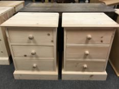 A near pair of pine three drawer bedside chests