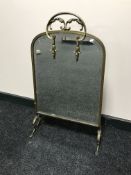 An early 20th century brass mirrored fire screen