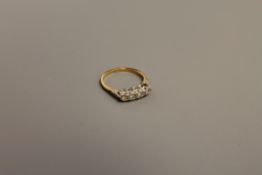 An 18ct gold four stone diamond ring