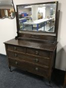 An Edwardian oak four drawer dressing chest