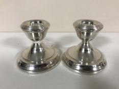A pair of silver dwarf candlesticks,
