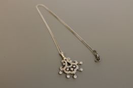 An 18ct white gold diamond set pendant,