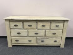 A painted pine nine drawer chest