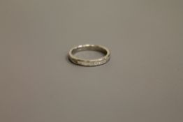 A platinum princess cut diamond half eternity ring, approximately 0.7ct, size M.