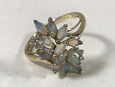 A 9ct gold opal and diamond cluster ring,