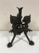 An ornate bronze three way lamp base on paw feet