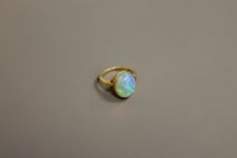 A fine quality opal ring set in 18ct gold, size K.