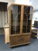 A 1930's oak domed topped display cabinet