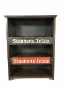 An early 20th century oak wall cabinet bearing two Stephen's Ink advertisements
