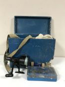 A wooden tackle box containing reels, floats,