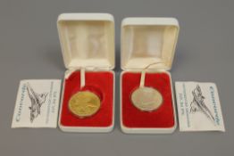 Two silver proof medals,