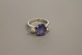 An 18ct white gold sapphire and diamond three-stone ring