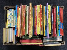 A box of vintage annuals and books