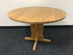 A circular pine kitchen table