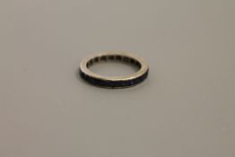 A white gold sapphire set eternity ring,