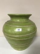A contemporary green ribbed pottery vase