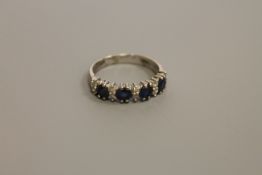 An 18ct white gold sapphire and diamond ring,