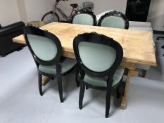 A stripped refectory table and four contemporary dining chairs