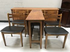 A late 20th century six piece teak dining room suite