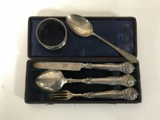 A silver knife fork and spoon in case,