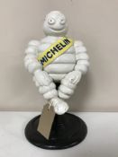 A cast iron sitting Michelin figure
