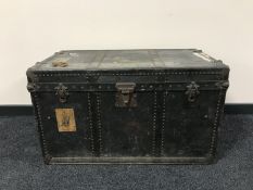 An early 20th century travelling trunk with metal mounts