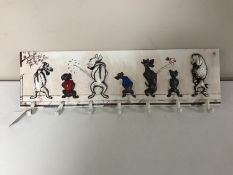 A cast iron dog cup rack