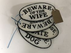 Four oval cast iron signs