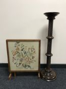 An oak framed tapestry fire screen and a torchere