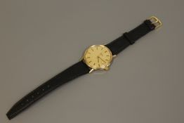 A gents 9ct gold Omega automatic centre seconds calendar wristwatch,