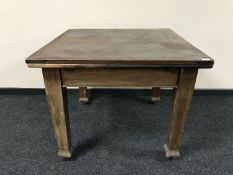 An early 20th century oak pull out dining table