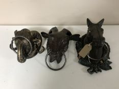 Three cast iron farm animal heads