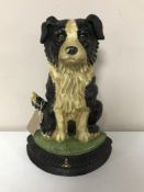 A cast iron sheep dog doorstop