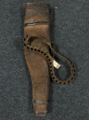 A leather leg o' mutton shotgun case and a cartridge belt